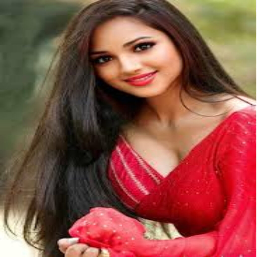 A GIRL 22 YEARS OLD NAME IS RAKHE WEARING RED DRESS HAVING LONG HAIR GIVING SEXY POSE IN SITTING WAY